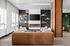 Chic lounge area with modern leather sofa, sleek fireplace, and elegant book display, creating an inviting ambiance.