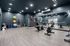 Modern fitness center with mirrored walls, exercise bikes, and vibrant workout equipment for an energetic lifestyle.