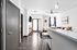 Modern apartment interior with sleek gray finishes, open living area, stylish bar seating, and cozy lounge space.