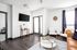 Modern living room with sleek hardwood floors, stylish furniture, and natural light streaming through elegant curtains.