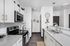 Modern kitchen with sleek stainless steel appliances, granite countertops, and stylish cabinetry offering a chic and functional cooking space.