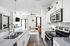 Bright modern kitchen with granite countertops adjacent to a cozy living area featuring stylish furnishings and natural light.