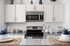 Sleek modern kitchen with stainless steel appliances, elegant white cabinets, and chic decor accents, offering a welcoming culinary space.
