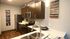 Modern kitchen with sleek dark wood cabinets, stainless steel appliances, and stylish decor for a contemporary touch.