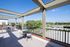 Expansive rooftop terrace with stunning views, modern furniture, and ample natural light.