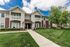 Charming two-story apartment building with attractive brick and siding exterior, surrounded by lush greenery and well-maintained lawns.