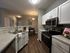 Modern kitchen with sleek appliances, spacious countertops, and a cozy dining area, perfect for culinary enthusiasts and intimate gatherings.