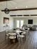Elegant living area with modern d&eacute;cor, featuring wooden beams, stylish seating, and ambient lighting, perfect for relaxation and social gatherings.