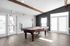 Bright and elegant game room with a luxury pool table, wooden floors, and ample natural light through large windows.