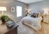 Inviting bedroom with elegant decor, plush bedding, soft lighting, and a spacious layout for ultimate comfort.
