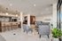 Contemporary open-plan living area with stylish furniture, a welcoming bar counter, and large bright windows.
