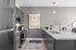 Modern kitchen with sleek cabinetry, granite countertops, and stainless steel appliances, featuring a stylish open space ideal for entertaining.