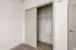 Modern closet with sliding doors and built-in shelving, offering ample storage in a chic apartment.