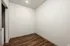 Chic modern space with sleek recessed lighting and elegant wood flooring, perfect for a home office or cozy reading nook.