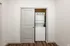 Modern apartment featuring a built-in compact laundry unit with sleek sliding doors, offering convenience and style.