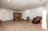Modern wellness room featuring a stylish sauna and luxurious massage chair, perfect for relaxation and rejuvenation.