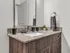 Elegant bathroom with modern vanity, granite countertop, and stylish fixtures.