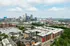 Breathtaking cityscape with modern apartment complex and vibrant downtown skyline, highlighting urban living at its finest.