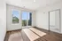 Bright and airy room with elegant hardwood flooring and large windows opening to scenic views, perfect for a modern living space.