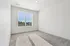 Bright and airy room with plush carpet and large window offering a peaceful view, ideal for a cozy bedroom or productive home office.