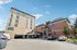 Modern apartment complex with stylish brick facade and ample parking in a welcoming neighborhood.