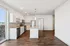 Modern, open-concept kitchen and living space with sleek stainless steel appliances, elegant lighting, and chic hardwood flooring.