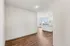 Bright and airy apartment kitchen with modern finishes, elegant pendant lighting, and large windows offering city views.