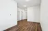 Sleek, modern corridor with elegant hardwood floors and pristine white walls, perfect for a stylish apartment layout.