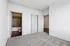 Bright and inviting bedroom with plush carpet, featuring a modern en-suite bathroom and sleek design.