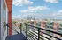 Charming apartment balcony with stunning city skyline views, perfect for urban living.