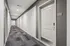 Modern apartment hallway with sleek lighting and stylish carpeting leading to a pristine white door, unit 516.