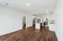 Modern open-concept living space with sleek kitchen design, hardwood floors, and ambient lighting.