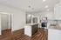 Modern kitchen with sleek stainless steel appliances, granite countertops, and elegant wood flooring, perfect for stylish living.