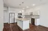 Modern kitchen with granite countertops, stainless steel appliances, and elegant wooden flooring, ideal for culinary creativity.