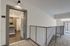 Inviting apartment entrance with sleek interior design, showcasing modern cabinetry and elegant lighting.