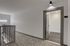 Welcoming apartment entrance with modern lighting and elegant patterned carpet, leading to a sleek interior space.