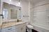 Modern bathroom featuring elegant granite countertops, sleek fixtures, and a pristine bathtub, offering a spa-like retreat.