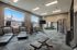 Bright and modern fitness center equipped with treadmills, elliptical machines, and a weight station, perfect for a healthy lifestyle.