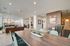 Contemporary open-concept living space featuring elegant decor, ample seating, and abundant natural light through large windows.