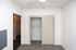 Pristine modern closet with sliding doors and plush carpet accentuating a bright, cozy interior.