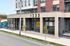 Modern urban apartment building facade at 1233 with large windows and stylish brick design. Now leasing at Union Square, offering vibrant community living.