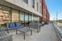 Chic urban terrace featuring stylish seating, modern architecture, and a captivating city view.