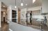 Modern kitchen with sleek granite countertops, stainless steel appliances, and stylish pendant lighting, creating an inviting culinary space.