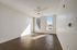 Bright, spacious room with modern ceiling fan and large windows inviting abundant natural light, perfect for a serene living area.