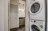 Modern apartment with in-unit stacked washer and dryer next to a sleek bathroom with contemporary lighting.