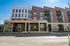 Modern urban apartment building with contemporary architecture, large windows, and vibrant exterior.