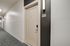 Elegant apartment corridor with a modern beige door numbered 417, softly lit by sleek wall-mounted lighting.