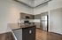Sleek modern kitchen with stainless steel appliances, elegant cabinetry, and a spacious granite countertop island.