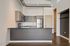Modern kitchen with sleek cabinetry, stainless steel appliances, and a spacious quartz countertop island, perfect for entertaining.