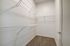 Spacious walk-in closet with elegant wire shelving, offering ample storage for a well-organized lifestyle.